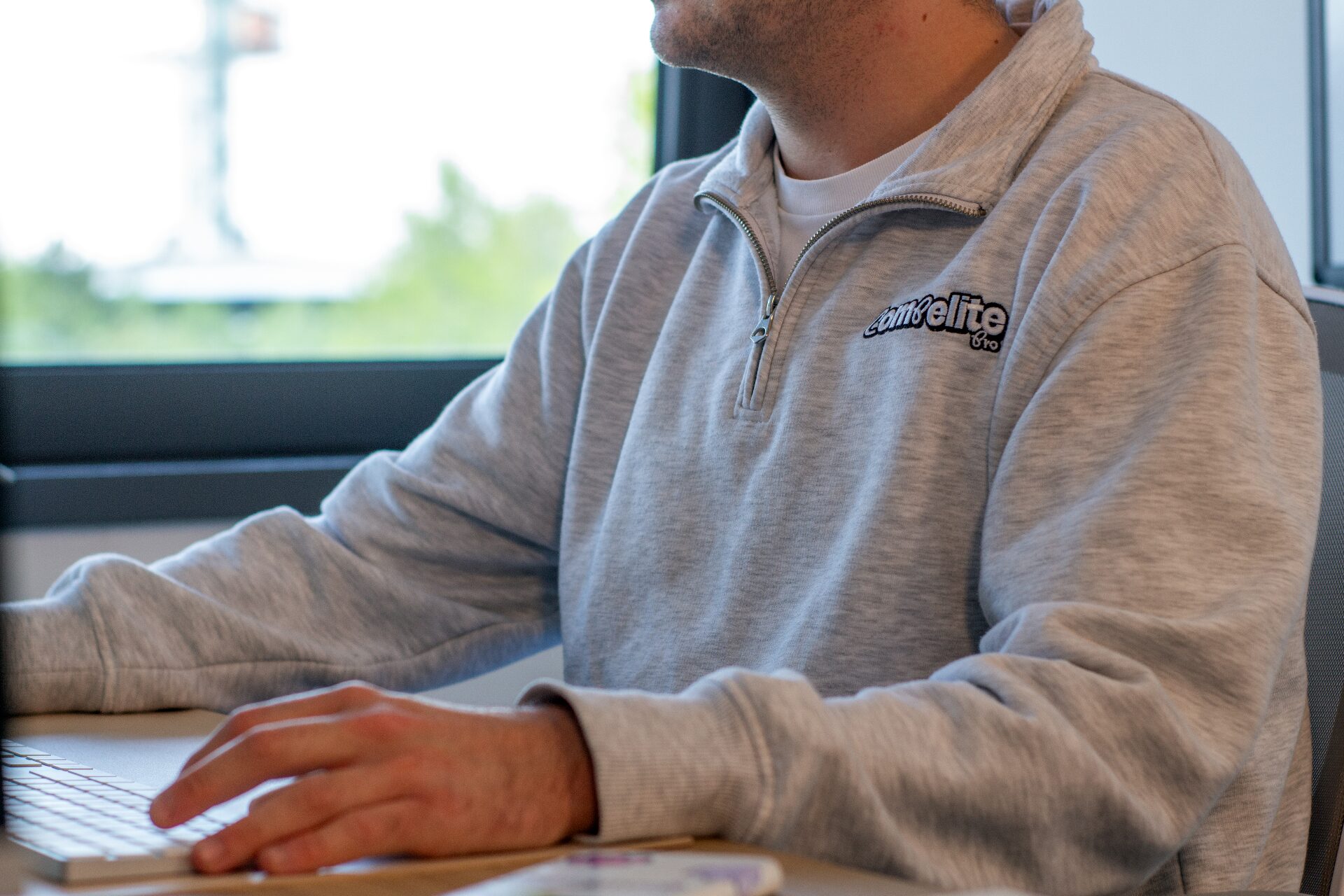 Compelite Pro team member working at a Mac in the Bristol office