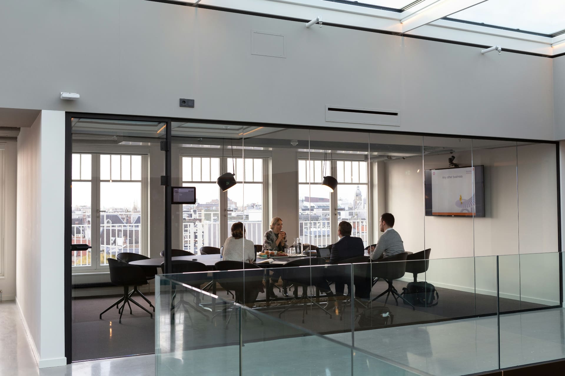 Professionals meeting in a modern glass-walled boardroom with city views — social media agency for professional services firms